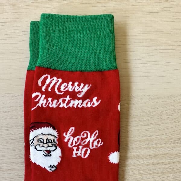 red merry christmas sock with a. green band