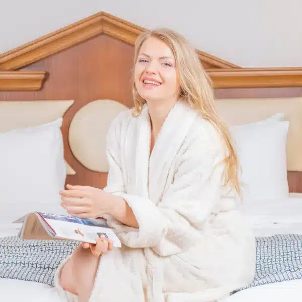 lady sat in creeam bath robe? dressing gown