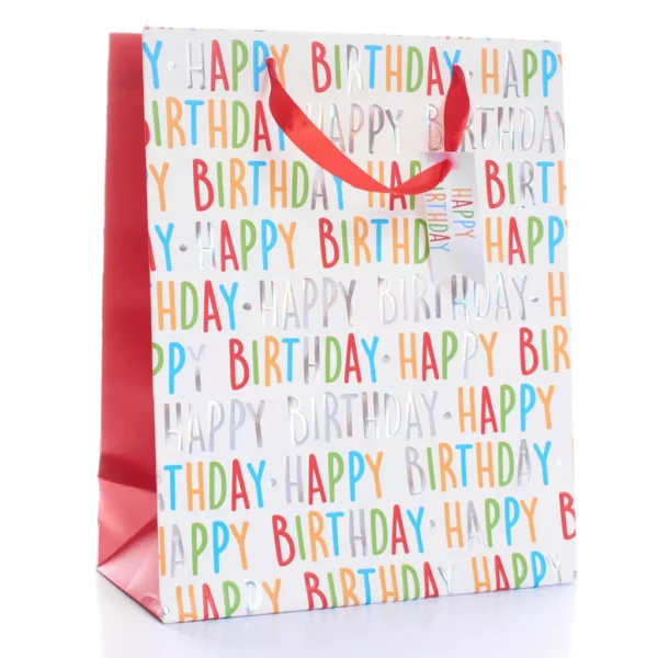 Medium Happy Birthday gift bag with colourful foil text, red satin handles, and matching gift tag — perfect for birthdays and celebrations.