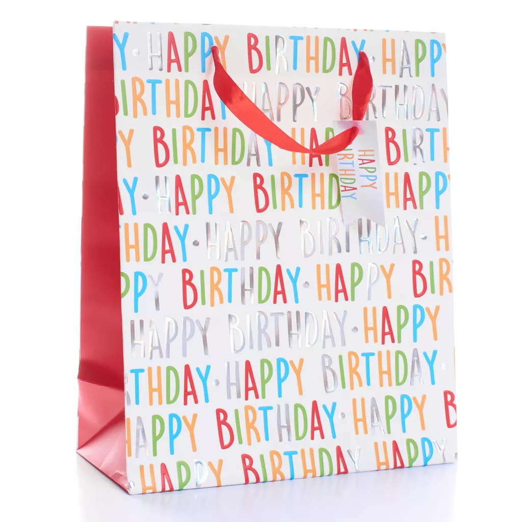 Medium Happy Birthday gift bag with colourful foil text, red satin handles, and matching gift tag — perfect for birthdays and celebrations.
