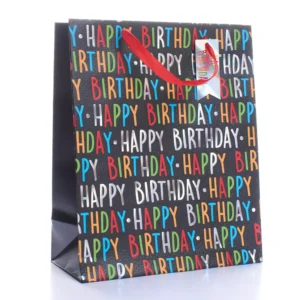 Medium black Happy Birthday gift bag with colourful foil text, red ribbon handles and holographic tag — stylish and fun birthday packaging.