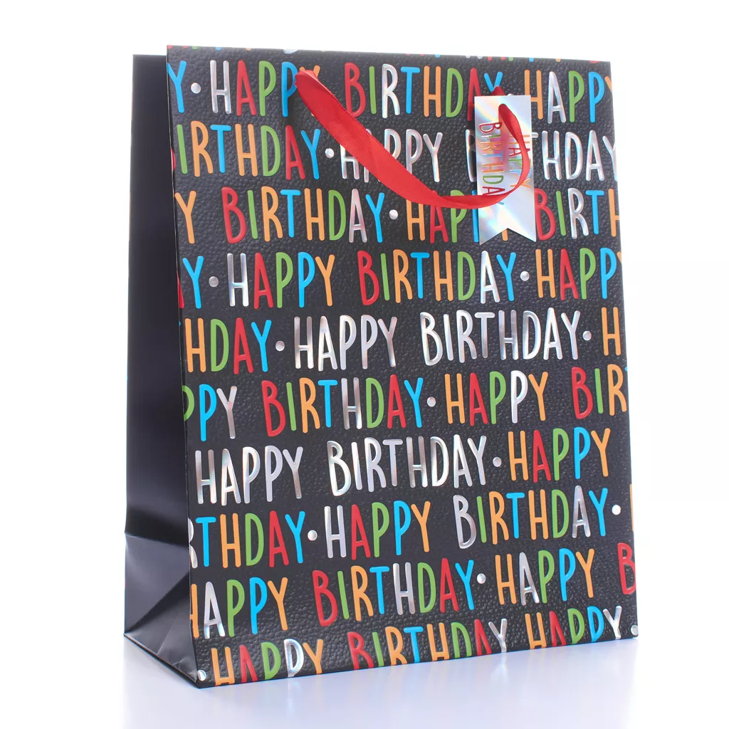 Medium black Happy Birthday gift bag with colourful foil text, red ribbon handles and holographic tag — stylish and fun birthday packaging.