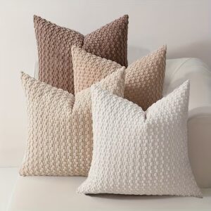 Soft oat textured cushion in a warm neutral tone, styled on a sofa