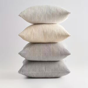 Neutral textured cushion collection styled on a sofa, featuring soft neutral tones and mixed textures